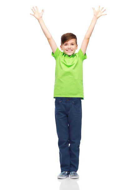 happy boy in polo t-shirt raising hands up - Foto, afbeelding
