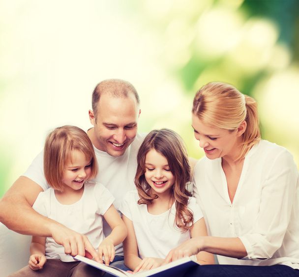 happy family with book at home - Foto, Imagem
