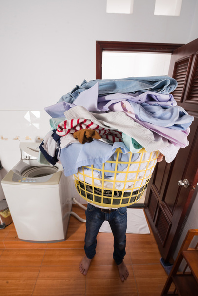 Househusband with big basket of dirty clothes - Fotó, kép