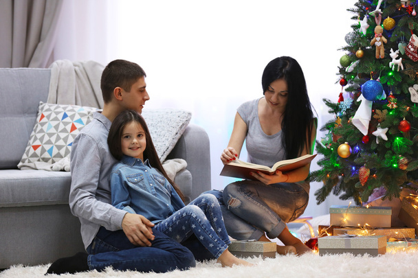 Happy family read book in the decorated Christmas room - Foto, Imagem