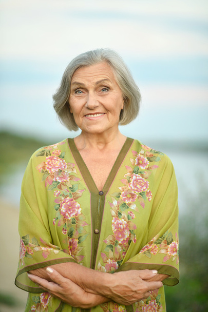 Elderly woman near lake - Foto, Imagem