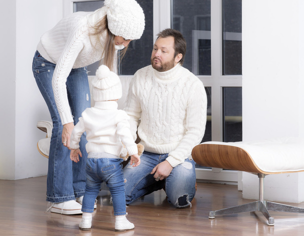 Family dressed in a white sweaters near the window. - Fotoğraf, Görsel