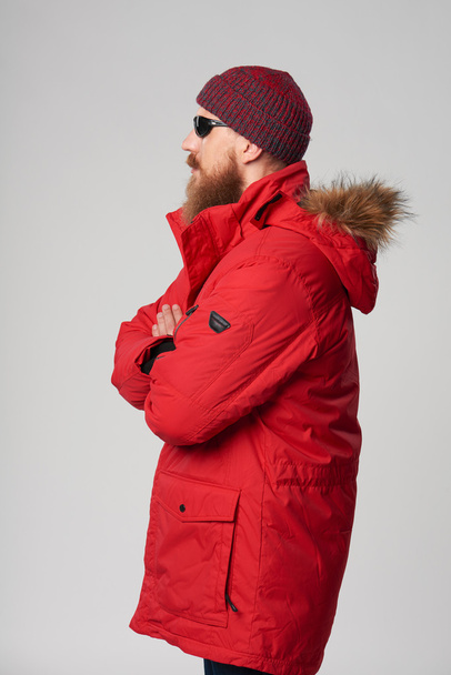 Man wearing red winter Alaska jacket  with fur hood on - Valokuva, kuva