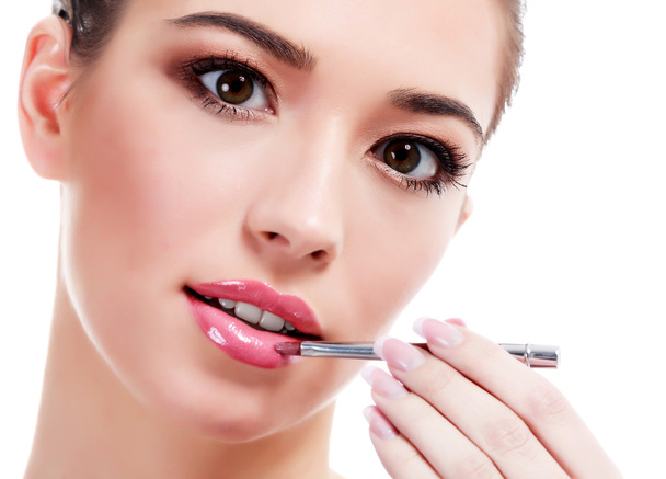Pretty woman with makeup brush - Photo, Image