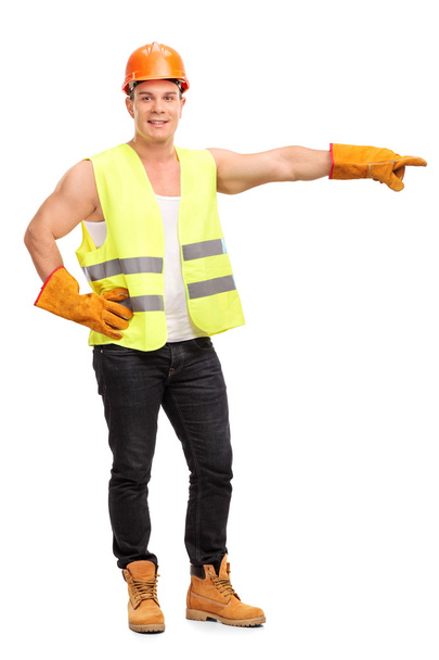 Young construction worker pointing with hand  - Fotografie, Obrázek