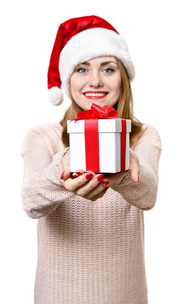 Young blond girl as santa`s hat with gift box. - Foto, Imagem