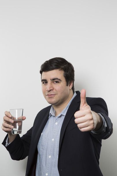 studio shot of happy businessman drinking water - Zdjęcie, obraz