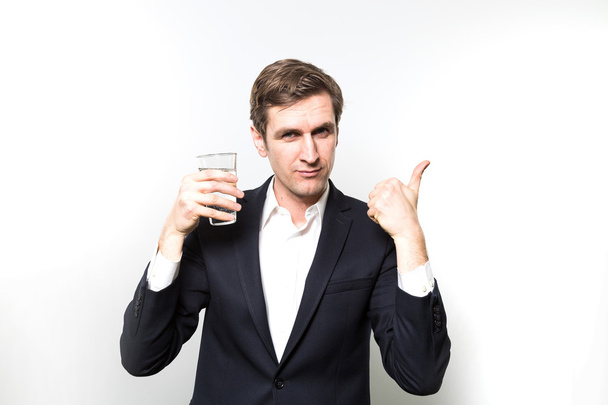 studio shot of happy businessman drinking water - Fotografie, Obrázek