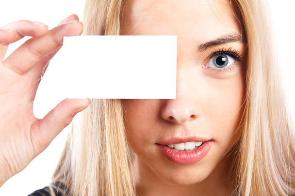 Young pretty woman holding blank card near her eye. Blank business vision - 写真・画像