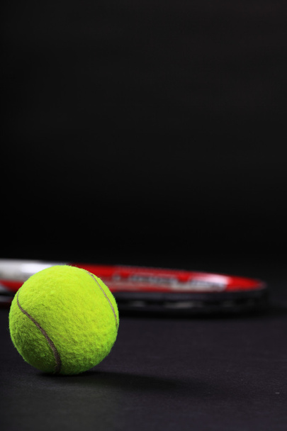 Tennis racket and balls on black background - Фото, зображення