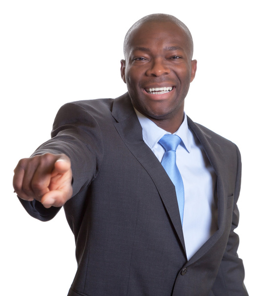 Pointing african businessman in a dark suit - 写真・画像