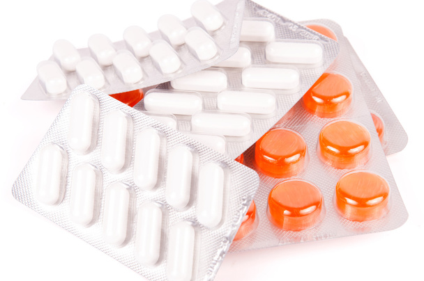 Συσκευασίες των λευκό και πορτοκαλί χάπια - Φωτογραφία, εικόνα