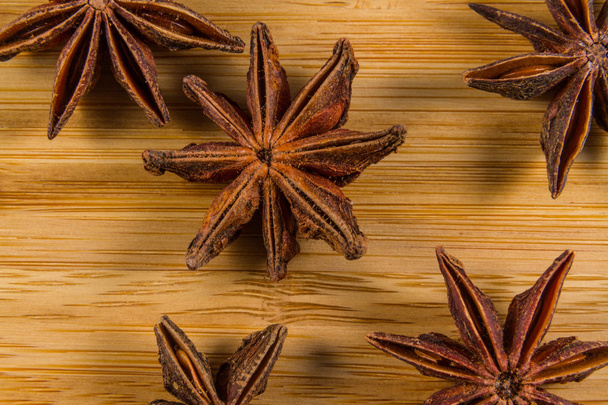 Star Anise, Illicium verum on a wood background. Close up. - Photo, Image