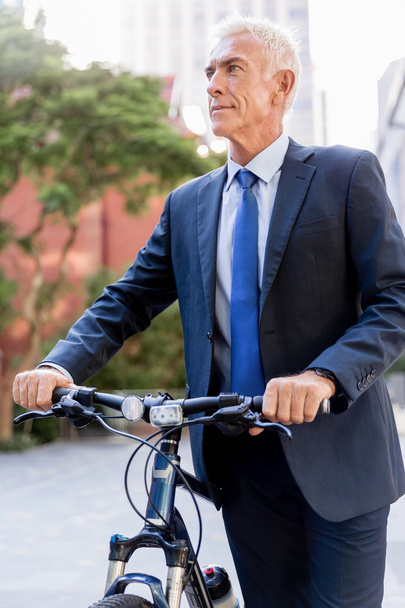 Successful businessman riding bicycle - Fotoğraf, Görsel