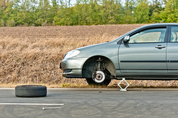 Car without tire on the road - Photo, Image