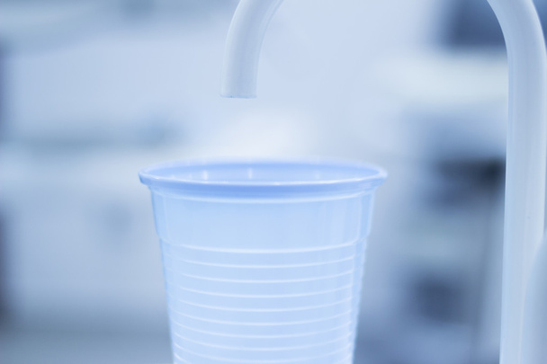 Dentist water rinse cup tap filler in dental clinic - 写真・画像