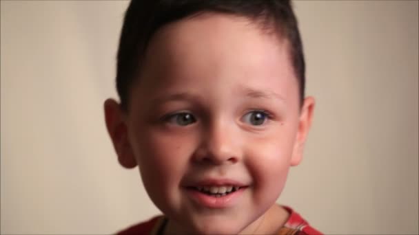 Little boy on a white background - Filmati, video