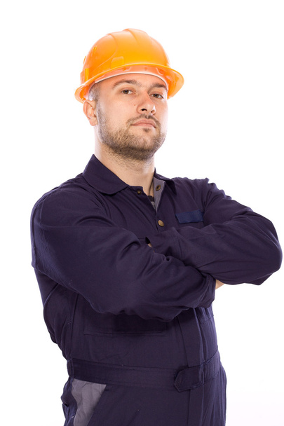 Portrait of the builder with visiting card on a white background - Photo, Image
