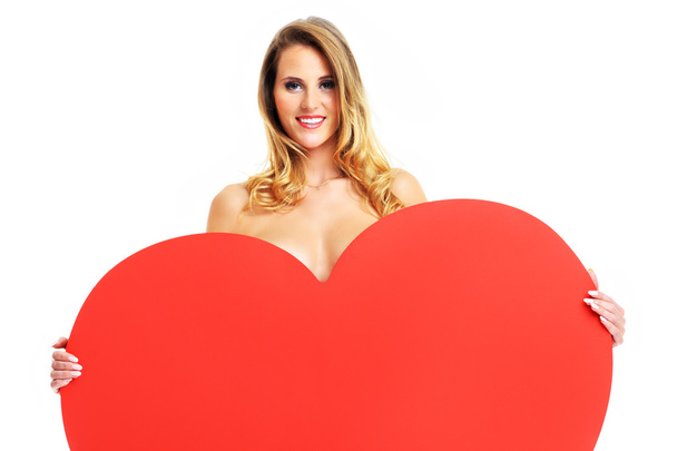 Sexy Valentine woman holding a big heart - Foto, afbeelding