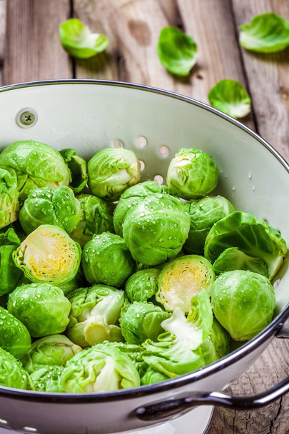 Fresh organic Brussels sprouts in a colander - Photo, Image
