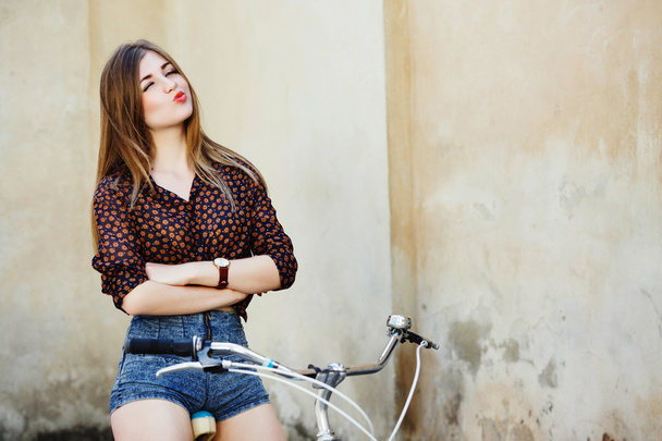 Charming young woman on the bicycle - Photo, Image