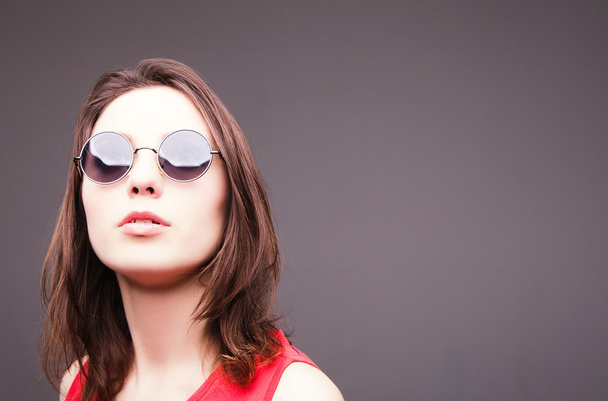 Fashion portrait of a beautiful brunette woman in glasses - Photo, Image