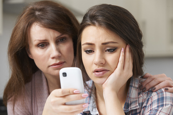 Mother Comforting Daughter Being Bullied By Text Message - Valokuva, kuva