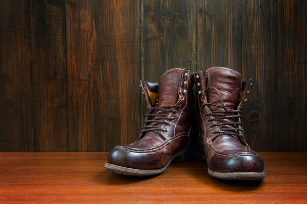 Vintage military boots on wooden background - Zdjęcie, obraz