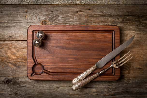 Chopping cutting board, seasonings and meat fork and knife  - Photo, Image