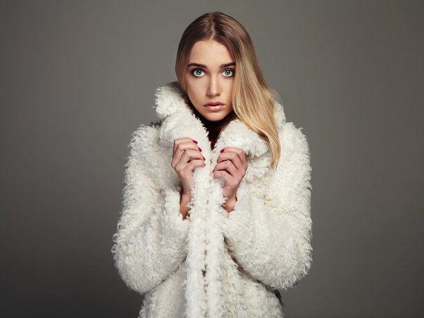beauty young woman in winter fashion wearing a fur.beautiful blond hair model girl - Photo, Image
