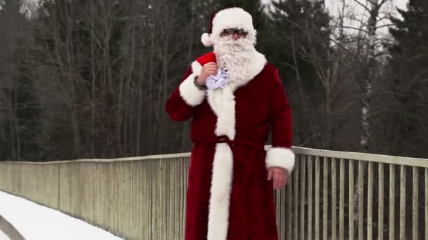 Santa Clause with gift bag and  baseball bat on the bridge - Footage, Video