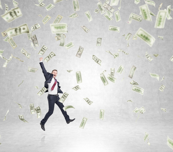 businessman jumping, money rain - Foto, afbeelding