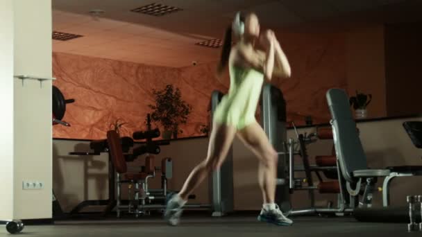 Mujer haciendo ejercicios de fitness sentadillas y saltos
 - Imágenes, Vídeo