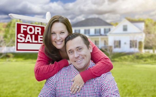 Happy Couple In Front of For Sale Sign and House - Photo, image