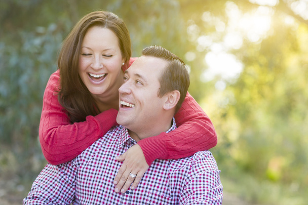 Attractive Caucasian Couple Laughing Outdoors - 写真・画像