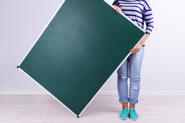 Girl holding big blackboard - Fotoğraf, Görsel