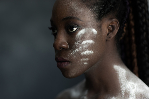 black human skin with wite stripes of powder - Foto, afbeelding