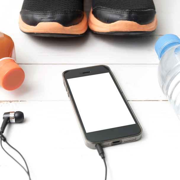 running shoes,orange juice,drinking water and phone - Foto, Imagen