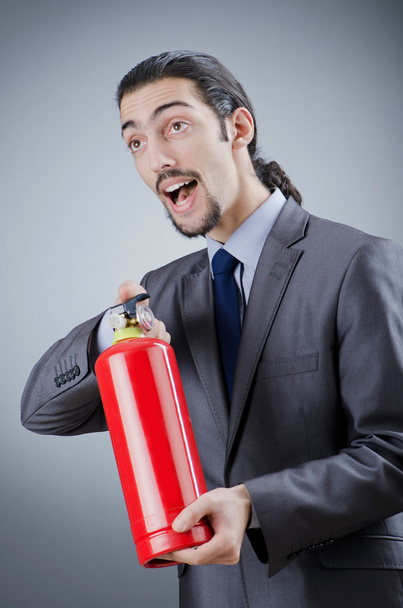 Man with fire extinguisher in firefighting concept - Foto, Imagem