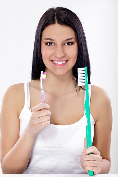Funny girl with small and big toothbrush - Фото, изображение