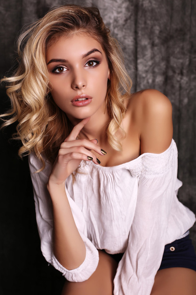 beautiful woman with blond curly hair and evening makeup,wears elegant blouse - Foto, immagini