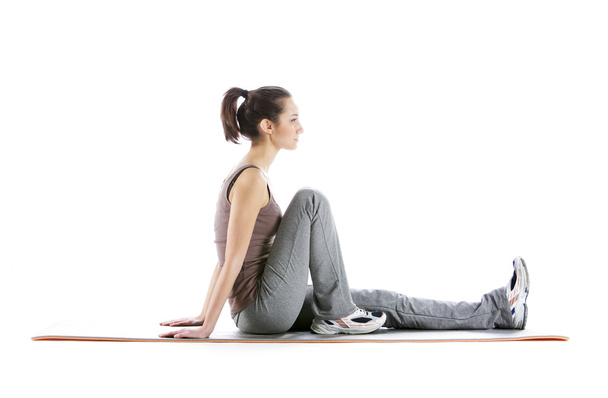 Fitness woman doing fitness exercise on mat . White background - Foto, imagen