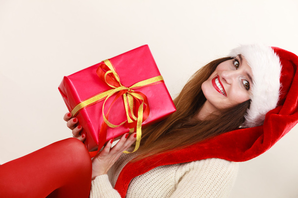 Woman in santa helper hat holds red gift box - Foto, Bild