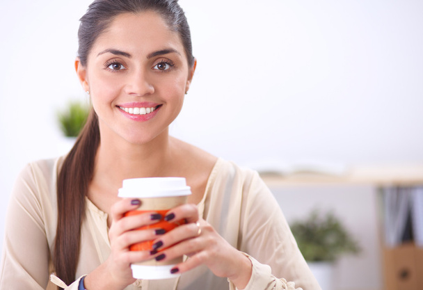Beautiful  businesswoman enjoying coffee in bright office - Zdjęcie, obraz