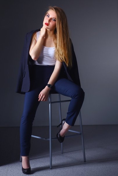 Young woman sitting on a chair - Foto, Bild