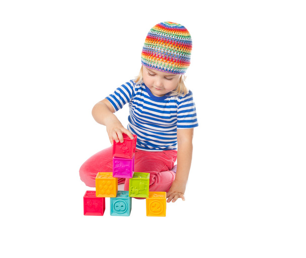 Little girl playing cubes sitting .  - Фото, изображение