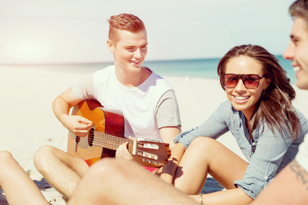 Beautiful young people with guitar on beach - Photo, Image
