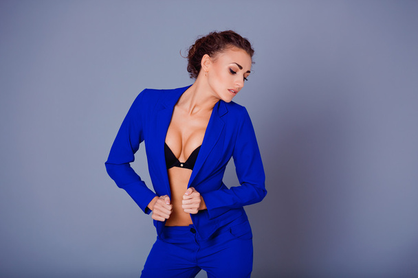 Portrait of gorgeous young caucasian attractive sexy woman with wearing blue jacket, pants and black bra . - Φωτογραφία, εικόνα