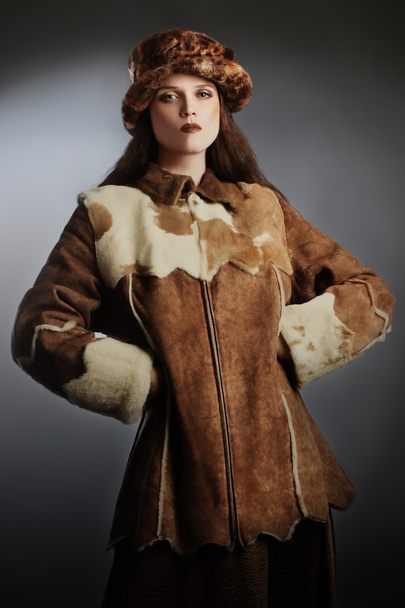 Sheepskin coat winter fashion woman in winter hat - Valokuva, kuva