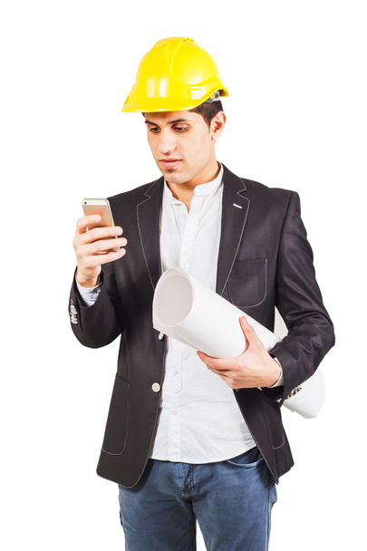 Young worker with the plan and the phone - Photo, Image